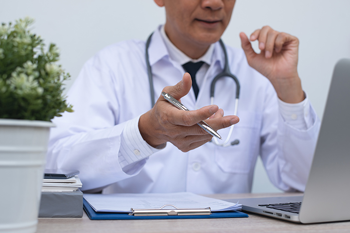 Doctor presenting to computer